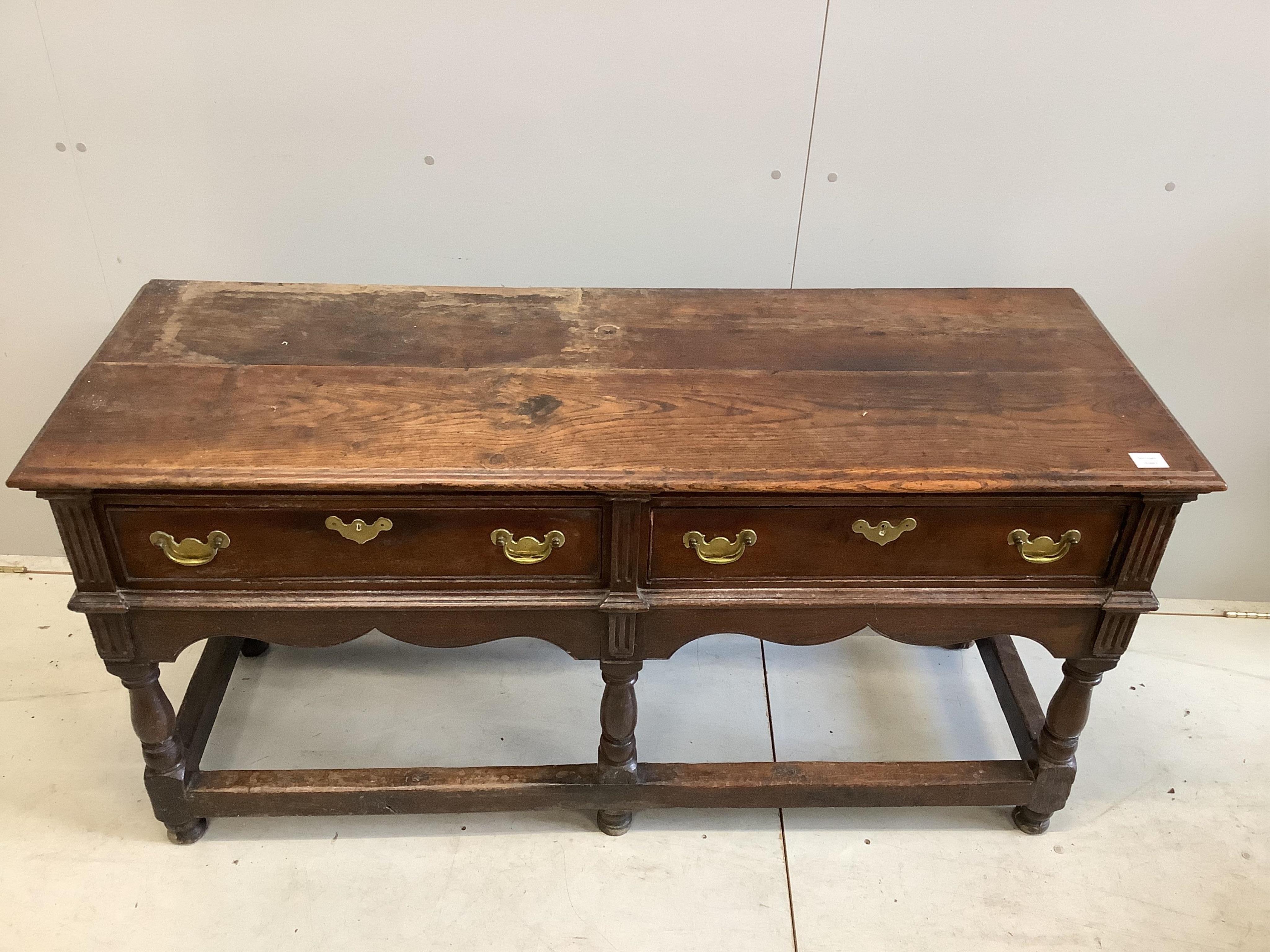 An 18th century oak low dresser base with two long drawers, width 150cm, depth 53cm, height 77cm. Condition - fair